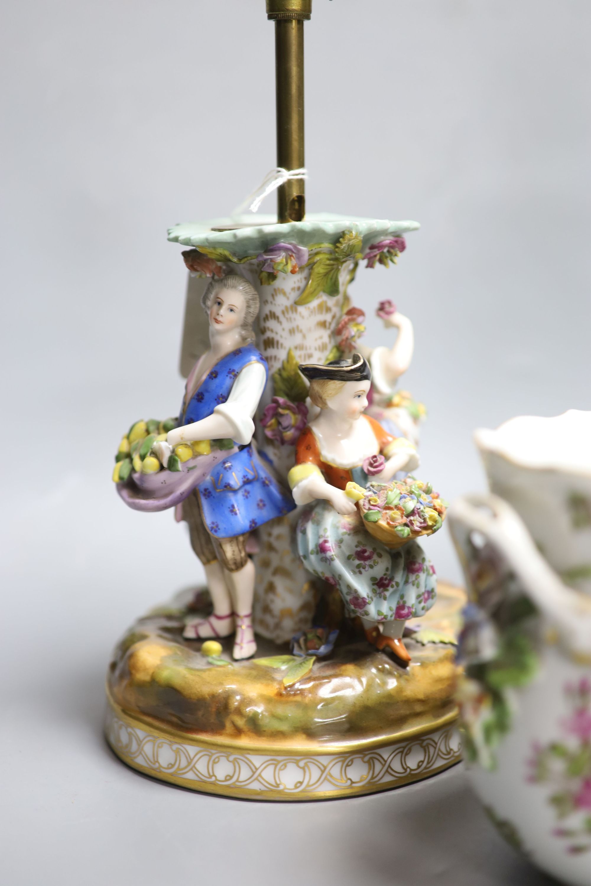 A Potschappel porcelain figural lamp, another similar lamp and a Dresden bowl with swags of flowers, tallest 28cm